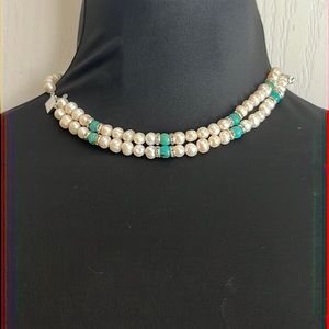 Pearl and turquoise necklace, but doubled as a bracelet.